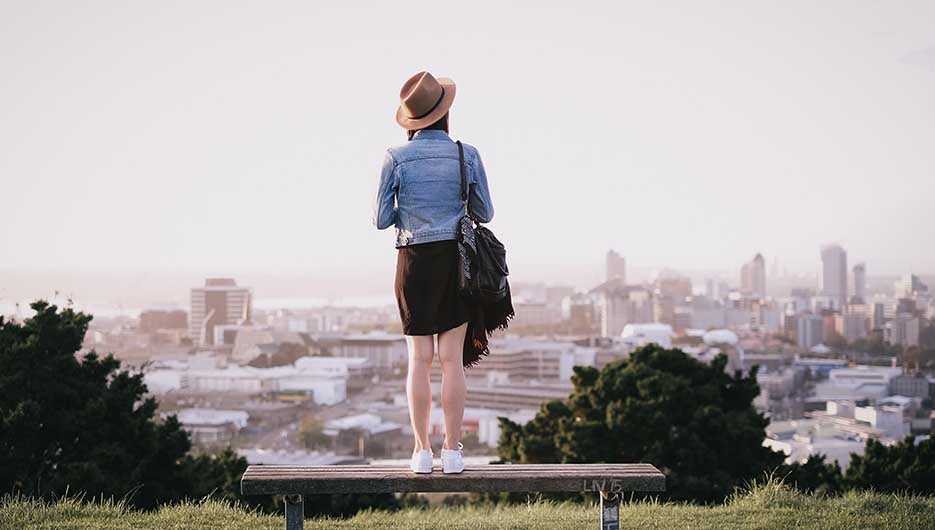 woman standing on bench