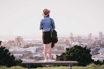 Woman smiling near building