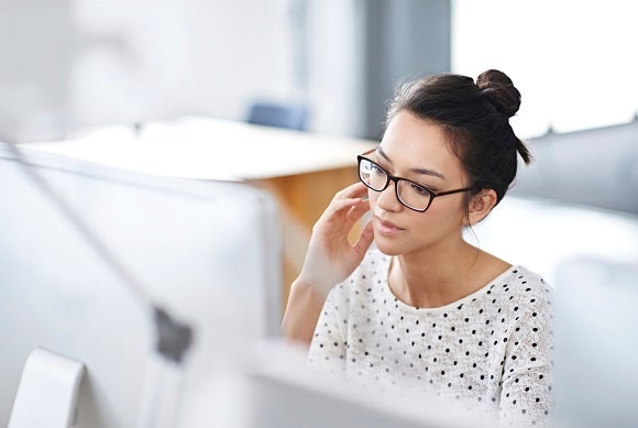 Shot of a young office worker sitting at her workstation in an office